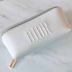 This Is A Dior White Faux Leather Cosmetic Bag. A Beautiful Gift With Purchase (Gwp) From Dior Beauty. Brand New And Unused. No Box. Details: White Faux Leather Exterior Frontal Dior Embossed Logo “D” Charm Zipper Pull Gold Tone Hardware White Plastic-Ky Interior Has Subtle Stars And Cd Logo Designs Measures At Approx. 7”L X 3”H X 3”W. Only Pouch Is Included; No Other Item Is Included. Perfect For Storing Makeup, Organizing Small Items Or For Traveling. Makeup Bag White, Makeup Organizing, Asthetic Stationery, Fun Beauty Products, Monogrammed Makeup Bags, Storing Makeup, Dior Cosmetics, Butterfly Photography, Leather Cosmetic Bag