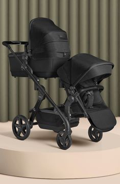 two baby strollers sitting next to each other