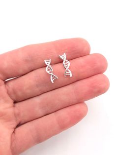 Sterling Silver DNA Earrings DNA Jewelry Biology DNA Climbers Science Twist Earrings Double Helix Biologist Gift Doctor Gift Science GiftThis DNA earrings is a must for a Biologist, a Doctor or a Nurse, bringing your habit to one more science level in your life and satisfy your nerdy needs!Comes on a beautiful display card ready for gift giving. Add a woven gift bag with a hand tied ribbon and box at checkout!Earrings: 14K Gold Filled or 14k Gold Finish or Sterling Silver or Rhodium (Silver) Fin Sterling Silver Pierced Ear Climbers As Gift, Silver Hypoallergenic Ear Climbers As Gift, Hypoallergenic Silver Ear Climbers As Gift, Hypoallergenic Silver Ear Climbers For Gift, Silver Pierced Ear Climbers For Anniversary, Sterling Silver Pierced Ear Climbers For Anniversary, Dainty Silver Hypoallergenic Ear Climbers, Dna Earrings, Doctor Jewelry