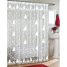 a white shower curtain with teddy bears on it and red rug in front of the bathtub