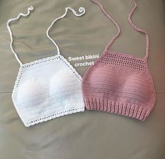 two crocheted bras sitting on top of a bed next to each other