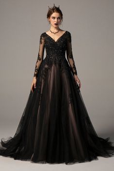 a woman wearing a black dress with sheer sleeves and lace detailing on the bouncy