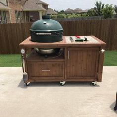 a large green egg sitting on top of a wooden cart