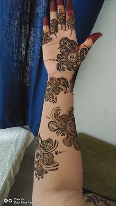 a woman's hand with henna on it