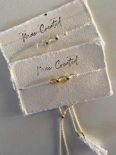 three bracelets with writing on them sitting in a white box next to each other