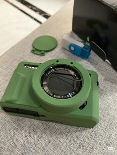 a green camera sitting on top of a table