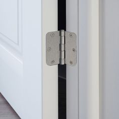 an open door with two metal hinges on it