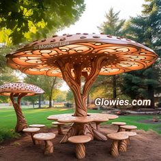 an outdoor table and benches made out of tree trunks with lights on them in the park