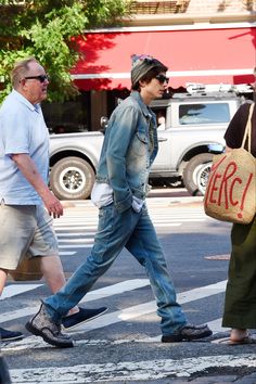 two men walking down the street with bags on their backs and one man carrying a sign that says erc