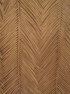 a close up view of a wooden wall with wavy lines on the wood grained surface