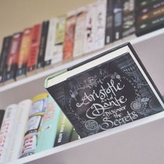 an open book sitting on top of a bookshelf