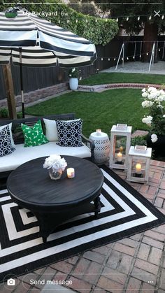 an outdoor living area with black and white furniture