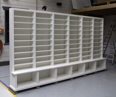 a large white bookcase sitting inside of a building