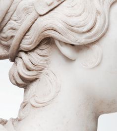 a close up of a statue of a woman's head