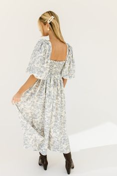 the search for the perfect all-season wedding guest dress is over. this stunning puff sleeve midi dress features a blue floral pattern + a flirty corset-inspired bodice. guaranteed to turn heads with every wear, it’s a must-have for cocktail parties, holiday dinners, or anytime you feel like frolicking. blue floral // midi length, scoop neckline, dramatic puff sleeves, back zipper closure, smocked bodice, fully lined model is 5'8" + wearing a small measurements are approximate + taken while layi Puff Sleeve Maxi Dress With Floral Print For Brunch, Floral Print Puff Sleeve Maxi Dress For Brunch, Puff Sleeve Floral Dress With Smocked Bodice For Brunch, Blue Floral Print Midi Dress With Puff Sleeves, Brunch Floral Print Midi Dress With Puff Sleeves, Puff Sleeve Midi Dress With Floral Print For Brunch, Blue Floral Print Midi Length Puff Sleeve Dress, Blue Floral Print Puff Sleeve Midi Dress, Puff Sleeve Floral Midi Dress For Brunch