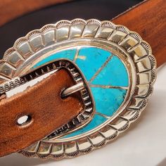 One of a kind sterling silver with inlaid turquoise ranger belt buckle set by Navajo artist Leonard Platero for Silver Cloud Jewelry in Albuquerque New Mexico.   The buckle is a long 2.5 inches and 2 inches wide.  The set includes 2 belt "loops" and a tip at the end, all sterling Silver with turquoise inlay.  The belt is 32 inches long. The buckle is signed Leonard Platero and Hallmarked with the Silver Cloud stamp. This is a wonderful addition to any collection for any occasion! Great gift for the Cowboy or Cowgirl! Southwestern Silver Concho Belt, Silver Southwestern Concho Belt, Turquoise Bohemian Belt With Concho, Southwestern Concho Belt Buckles For Ranch, Bohemian Concho Belt Buckles For Western-themed Events, Southwestern Concho Belt For Western-themed Events, Southwestern Antique Belt Buckle For Rodeo, Adjustable Southwestern Concho Belt Buckles, Adjustable Turquoise Western Belt Buckles