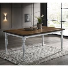 a wooden table sitting on top of a white rug