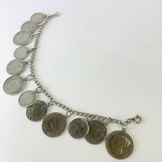 "Beautiful vintage sterling silver bracelet with 12 genuine silver Canadian coins. This bracelet measures approximately 7.5\" long. Each coin has been individually secured with it's own O-ring. All links and solders are intact with no issues. The clasp sticks somewhat but closes securely. The clasp is stamped for sterling silver. Item will arrive in gift packaging. Please see pictures, ask questions, and check out my other vintage jewelry treasures!" Silver Coin-shaped Engraved Bracelets, Vintage Coin-shaped Engraved Bracelets, Vintage Silver Coin Bracelet, Vintage Silver Coin Bracelets, Canadian Coins, Mc Donald, Coin Bracelet, Georg Jensen, Hinged Bangle