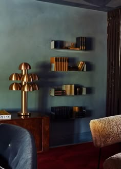 a living room filled with furniture and bookshelves next to a wall mounted book shelf