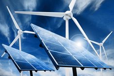 three windmills with solar panels and wind turbines in the background