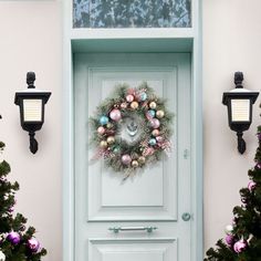 a green door with a wreath on it