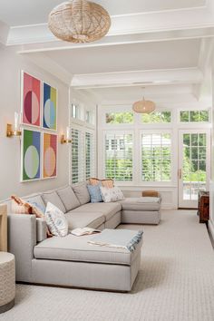 a living room filled with furniture and lots of windows