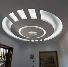 the ceiling in this room is made up of white paint and has round lights on it