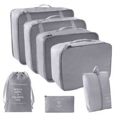 four pieces of luggage are shown in grey and white