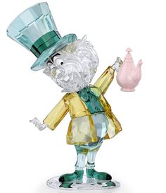 a glass figurine with a green top hat holding a pink teapot in it's right hand