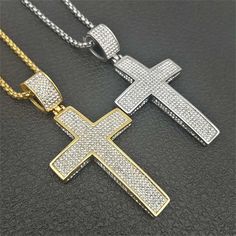 This XL Full Pave Cross Charm is fully encrusted with six rows of clear stones. The extra large size of this cross makes the charm a noticeable and eye-catching piece. Includes a 20" 2.5mm Rounded Box Chain. Charm Size: 74mm x 37mm PVD Plating guarantees a long-lasting finish. Diamond Cross Necklace Iced Out, Silver Iced Out Cross Pendant Necklace, Iced Out Cubic Zirconia Cross Pendant Necklace, Iced Out Cross Necklace With Cubic Zirconia, Crystal Cross Necklace With Bling, White Iced Out Cross Necklaces, White Iced Out Cross Necklace, Rhinestone Cross Pendant Necklace As Gift, Pendant Necklace Men