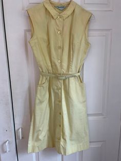 Adorable vintage 50s/60s button down summer dress.  Despite being in not great condition (several marks pictured), it's still so cute! Could probably improved with the right care/products. Sold as is. Measurements taken flat: Waist: 13" Pit to pit: 17" Waist to hem: 20" Top of neck to waist: 16" Shoulder to shoulder: 15" Vintage A-line Dress With Buttons, 1950s A-line Dress With Buttons, 1950s A-line Vintage Summer Dress, Retro A-line Dress With Button Closure, Knee-length Summer Vintage Dress, Retro Vintage Dress With Button Closure, Retro Vintage Dress With Buttons, Classic Cotton Vintage Dress For Spring, Vintage Sleeveless Buttoned Dress