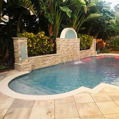 a small pool with a waterfall in the middle