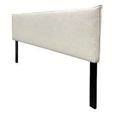 an upholstered headboard with black legs and a white fabric cover on it