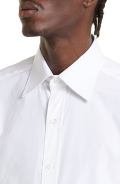 Standout details like tulip-edge mitered cuffs and mother-of-pearl buttons put Tom Ford's stamp on this Italian-made poplin shirt tailored in a slim fit. 33" length; 44" chest (size 44) French placket Cutaway collar Mitered, two-button cuffs 100% cotton Machine wash, line dry Made in Italy Designer Clothing Timeless Collared Dress Shirt With Button Cuffs, Classic Business Shirt With Cuffed Sleeves, Timeless Dress Shirt With Button Cuffs For Daywear, Timeless Daywear Dress Shirt With Button Cuffs, Designer Formal Shirt With Button Cuffs, Spread Collar Dress Shirt With Button Cuffs, Luxury Dress Shirt With Button Cuffs And Spread Collar, Luxury Dress Shirt With Spread Collar And Button Cuffs, Classic Shirt With Cuffed Sleeves And Collar