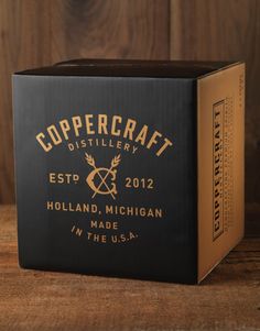 the box for coppercraft distillerry sits on a wooden table