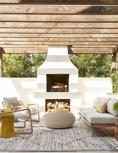 an outdoor living area with furniture and a fire place