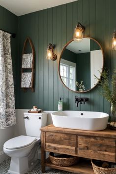 a white toilet sitting next to a bathroom sink under a mirror on top of a wooden cabinet