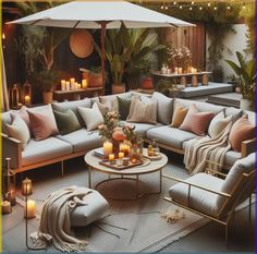 a living room filled with lots of furniture and candles on top of the table next to an umbrella