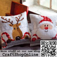 two cross stitch christmas pillows with santa and reindeer on them, one has a qr code