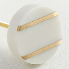 a close up of a white and gold object