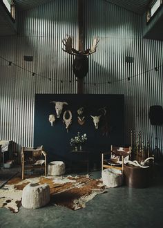 a living room with deer heads on the wall