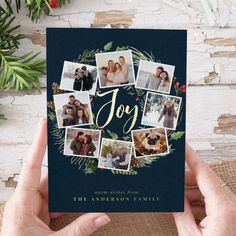 a person holding up a christmas card with photos on it and the word joy written in gold