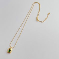 Add a touch of elegance to any outfit with our Emerald Necklace. Featuring a brilliant green CZ stone and multiple layers of 14k gold plating, this 18" necklace is both waterproof and anti-tarnish for everyday wear. Perfect for any occasion. Everyday Green Jewelry With Clavicle Chain, Elegant Gold Emerald Necklace For Everyday, Elegant Everyday Emerald Necklace In Gold, Green Gold Plated Jewelry With Delicate Chain, Gold Plated Tarnish Resistant Necklace With May Birthstone, Everyday Elegant Gold Emerald Necklace, Everyday Green Gold-plated Jewelry, Gold Plated Tarnish Resistant Necklace For May Birthstone, Everyday Green Gold Plated Jewelry