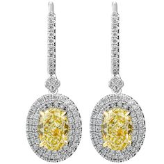 Classic, bold and elegant, these earrings will go great with evening attire or for every day wear Mounted in Platinum 950 and 18k Yellow gold cup to make Yellow Diamonds pop, these earrings featuring exceptional pave work , encrusted with almost 1.7ct of white full brilliant cut diamond creating double halo around Light Yellow Oval diamonds. Lever back also encrusted with pave, you won`t miss a sparkle! Center stones details: 2 Light Yellow Oval diamonds 0.70ct each stone Measurements: 8.34mm x Oval Diamond Earrings, Oval Diamond Earring, Diamonds Earrings, Yellow Diamonds, Gold Cup, Double Halo, Oval Earring, Women Diamond, Yellow Gold Earring