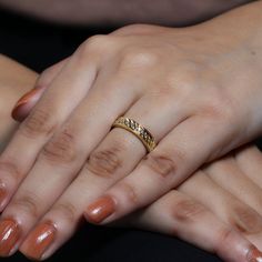 two women's hands holding each other with their wedding rings on top of them