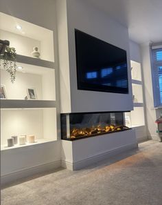 a flat screen tv mounted to the side of a wall next to a fire place