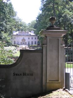 the entrance gate to swan house is shown