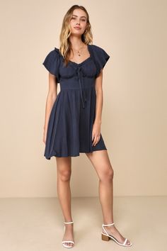 Let your precious side show off in the Lulus Adorable Personality Navy Blue Linen Off-the-Shoulder Mini Dress! This sweet dress has a lightweight, woven linen-blend fabrication that shapes a ruffle-trimmed, elasticized off-the-shoulder neckline that flows into fluttery short sleeves. Fitted bodice features seamed cups and a decorative tying detail at the center. High waist sits atop a skater skirt that finishes at a cute mini hem. Hidden side zipper. Fit: This garment fits true to size. Length: Casual Linen Mini Dress For Brunch, Chic Off-shoulder Linen Dress, Summer Off-shoulder Linen Dress, Chic Blue Linen Mini Dress, Casual Linen Dress For Date Night, Knot Tie Dress, Side Show, Navy Blue Linen, Mini Skater Dress