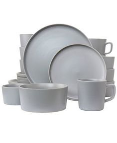 a set of white dishes with cups and saucers