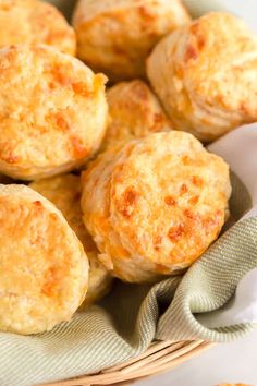 a basket filled with cheesy biscuits on top of a table